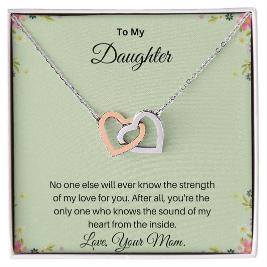 Interlocking Hearts necklace with cubic zirconia crystals in polished rose gold and surgical steel, elegantly packaged for gifting.